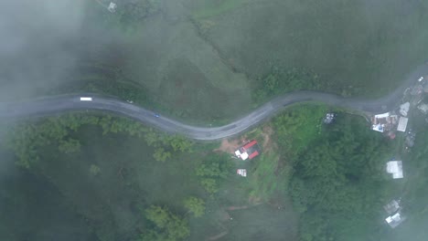 scenic and cinematic aerial view of a rural road from the clouds.