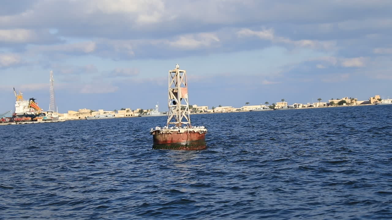 A large buoy in the middle of the sea during the day
