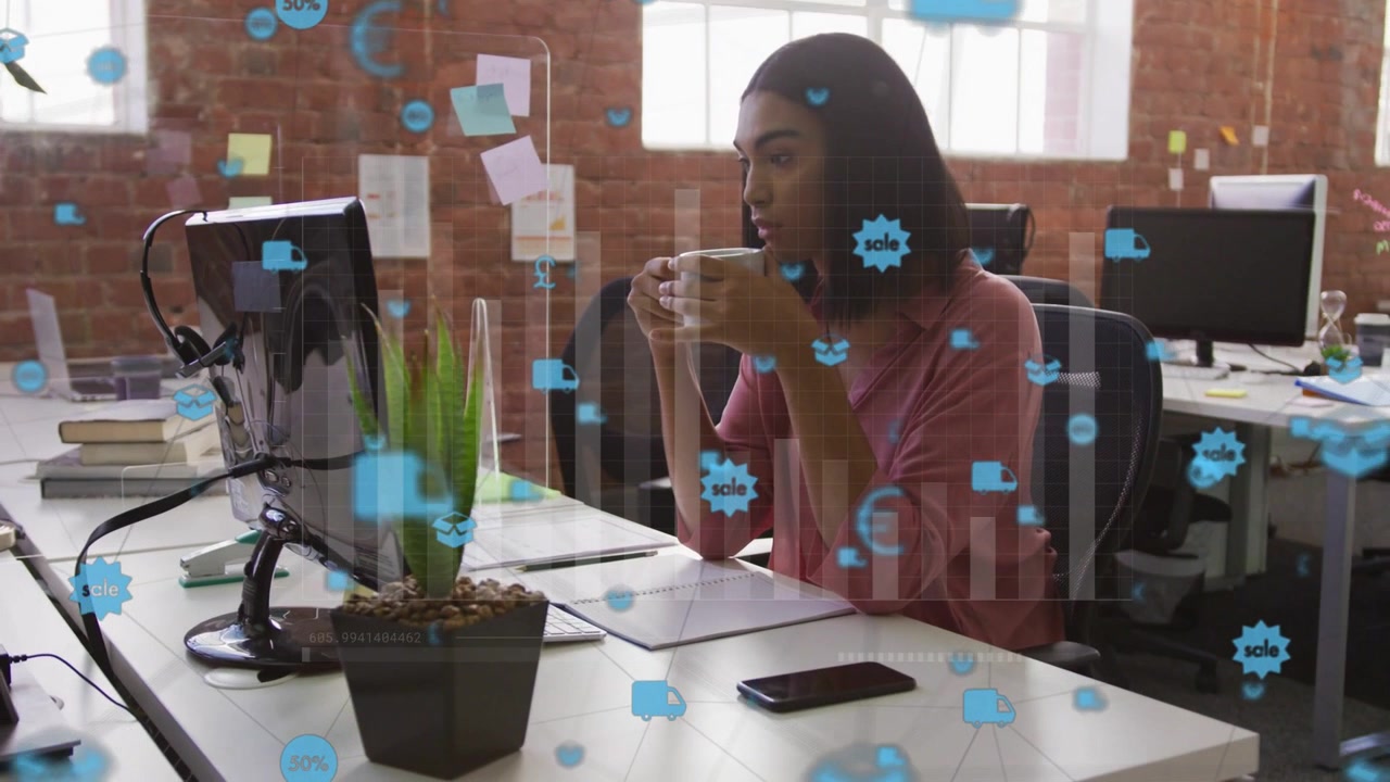 Woman sitting at desk reading business data on screen as blue overlay appearing fading showing desk