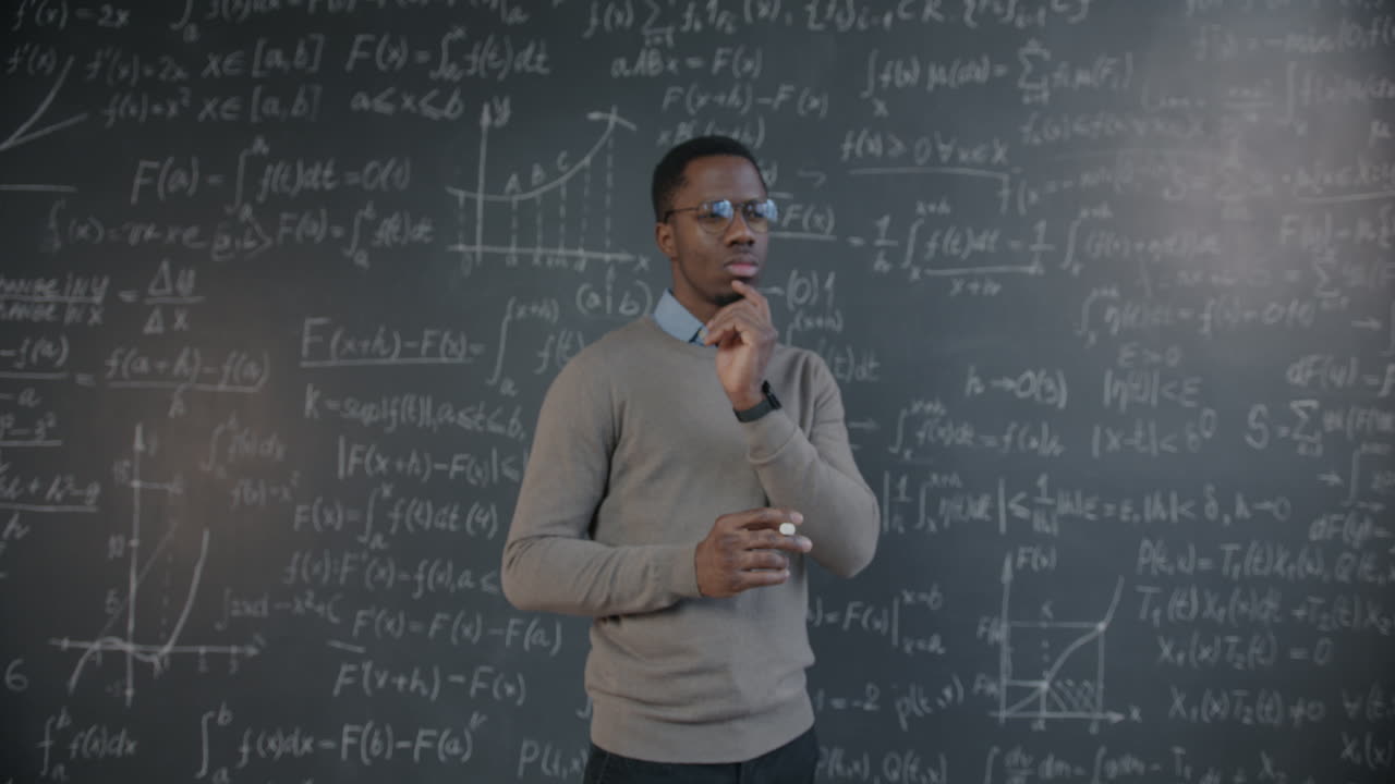 Man Thinking About Math Equations on a Chalkboard