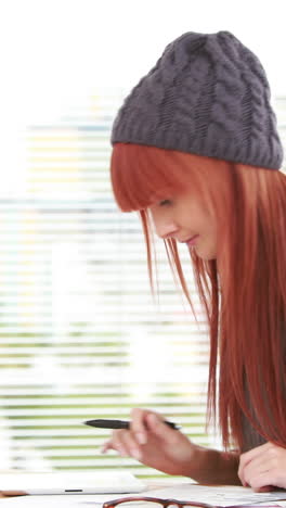 red haired hipster using a tablet