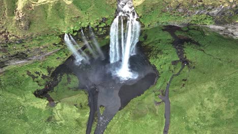 pullback revealed seljalandsfoss waterfall on sheer cliffs in southern iceland