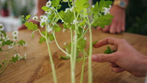 flower seller making bouquet composition in shop. closeup florist woman hands.