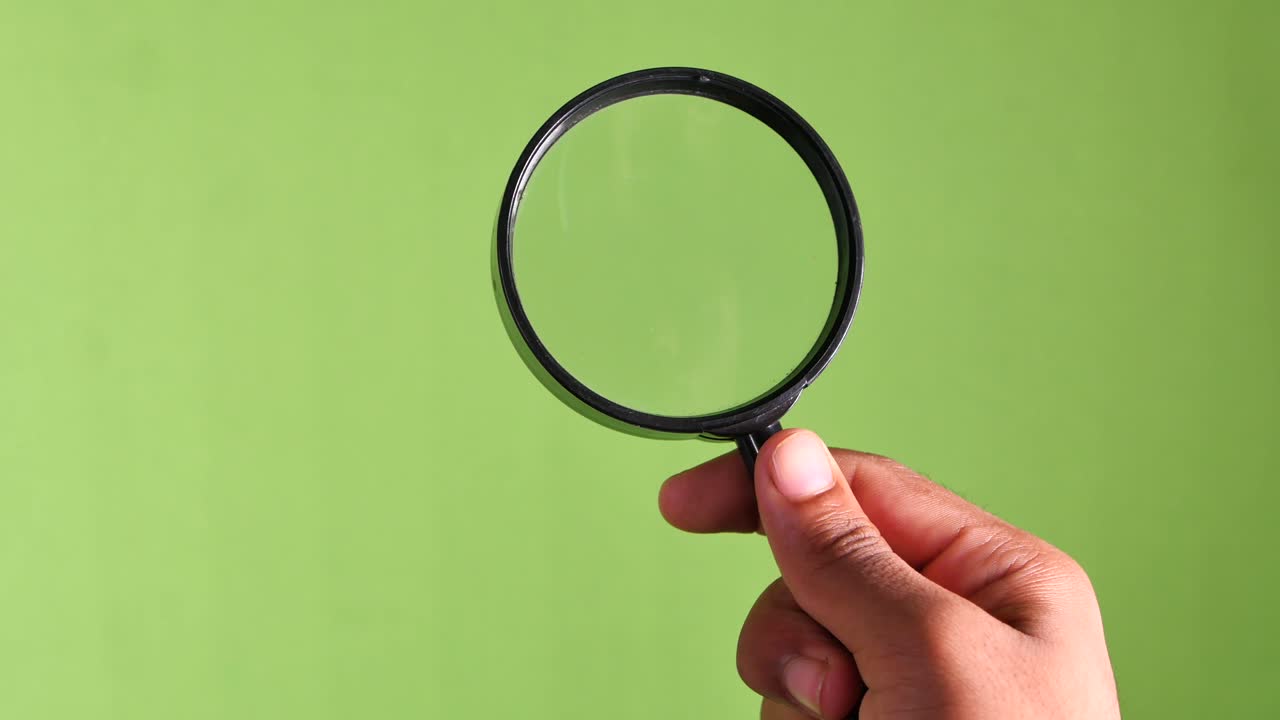 Hand Holding a Magnifying Glass