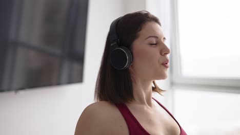 Woman-doing-stretching-warmup-in-headphones