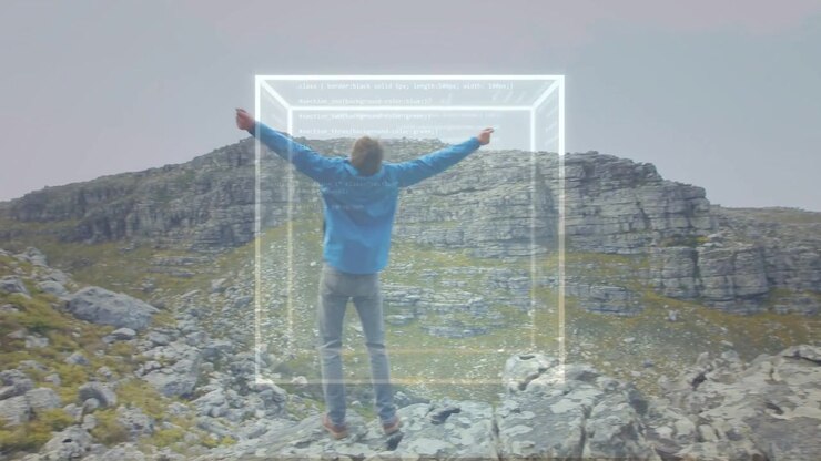 Male hiker stepping onto rock ledge and causing wireframe cube, HUD aligning for technology mapping