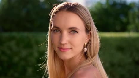 smiling lady looking at camera outdoors