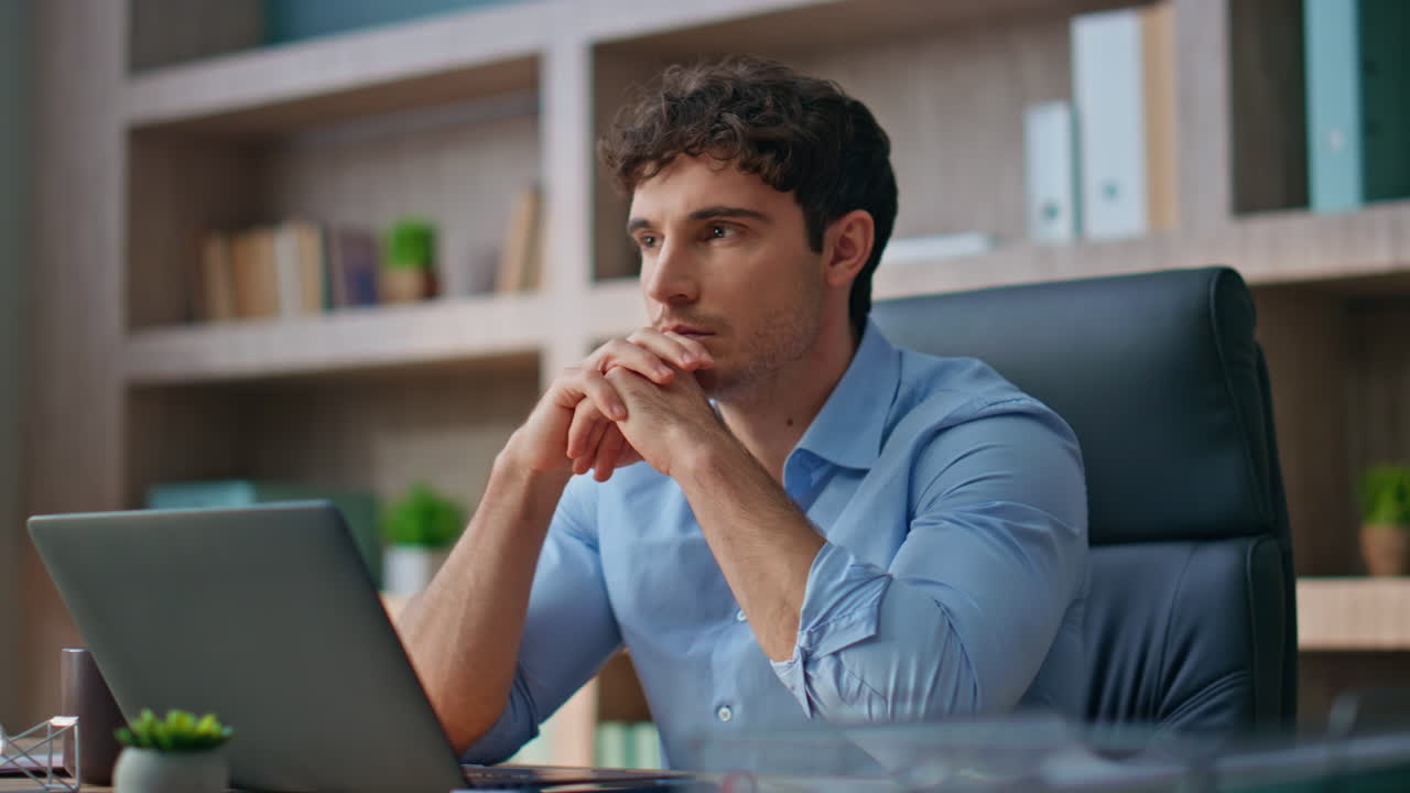 Pensive man considering decision at modern workspace. Closeup executive thinking