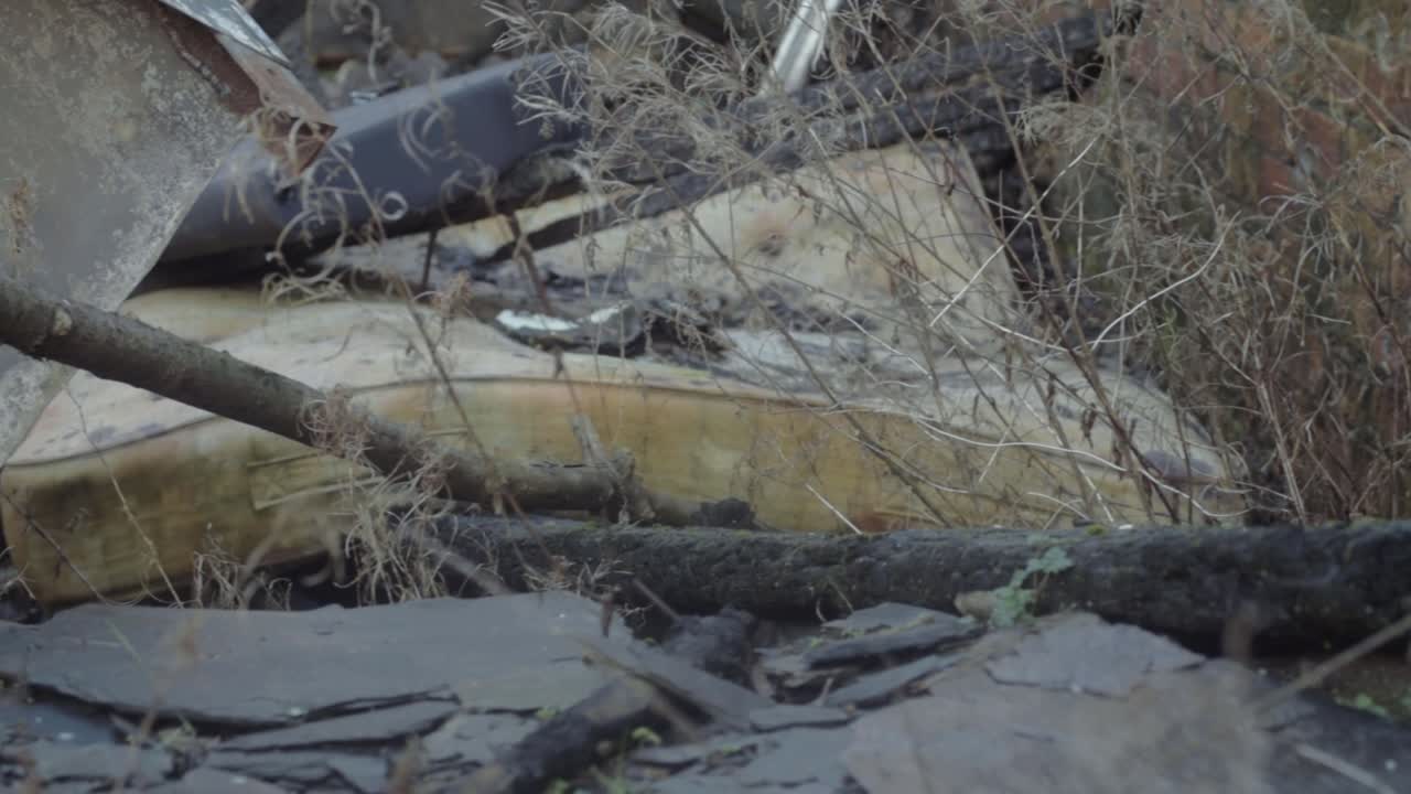 Grunge dirty mattress dumped in pile of rubble