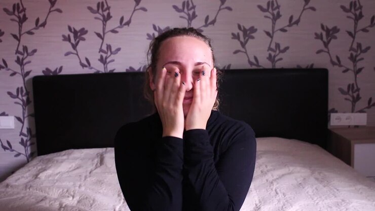 Teenage girl blocking her face and falling back