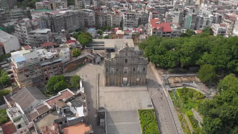 tilt reveal aerial view of famous ruins of saint paul's, macau on sunny evening