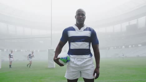 Rugby-player-standing-with-rugby-ball-in-the-stadium-4k