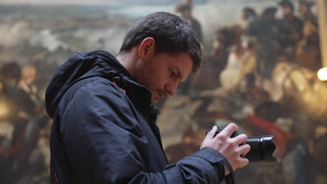 Young-tourist-man-taking-photos-inside-the-Palace-of-Versailles,-France