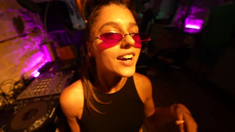 young woman djing at a nightclub