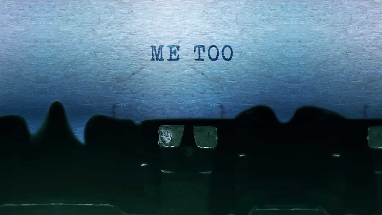 Me too word closeup being typing and centered on a sheet of paper on old vintage typewriter