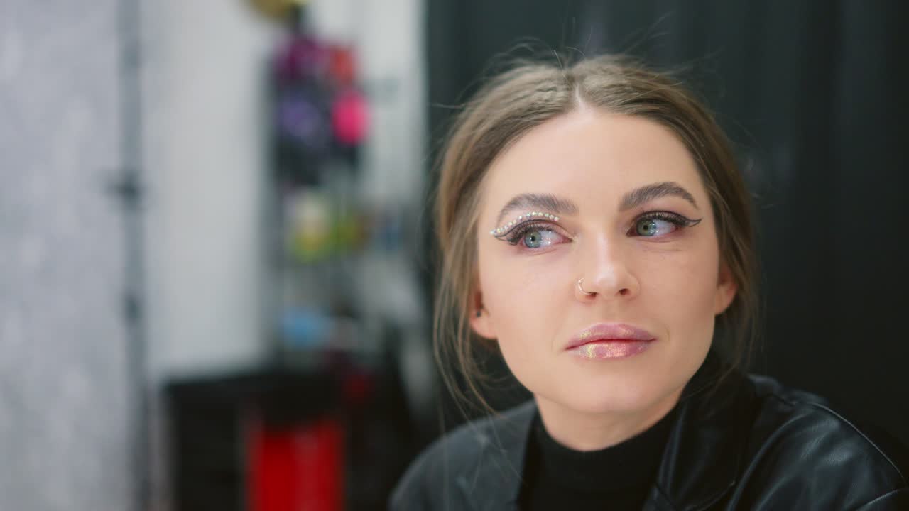 Woman Applying Rhinestone Eye Makeup