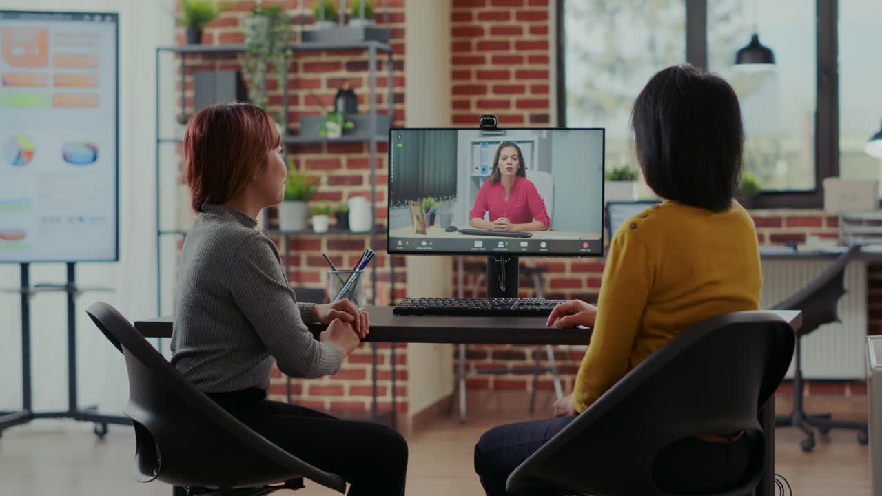 Asian team attending job interview on online video call