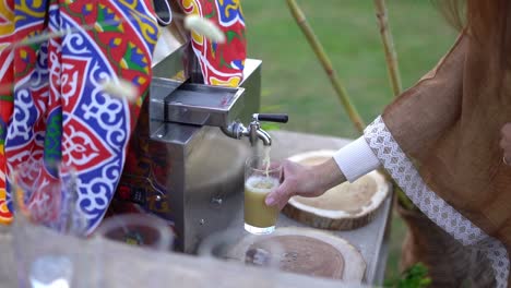 fresh sugarcane juice being extracted using a traditional pressing machine, close up shot, insert shot
