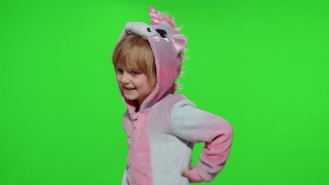 Little-blonde-child-girl-smiling,-dancing,-celebrating-in-unicorn-pajamas-costume-on-chroma-key