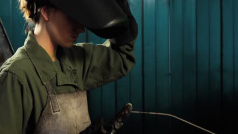 female welder holding welding torch