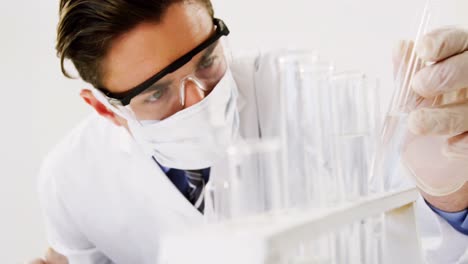 lab technician checking sample in tube