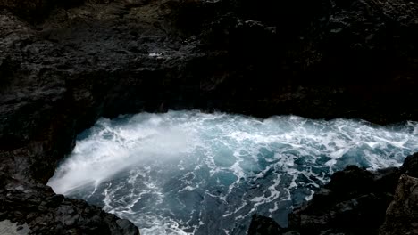 big waves crashing on cliff of lava rocks.time lapse.