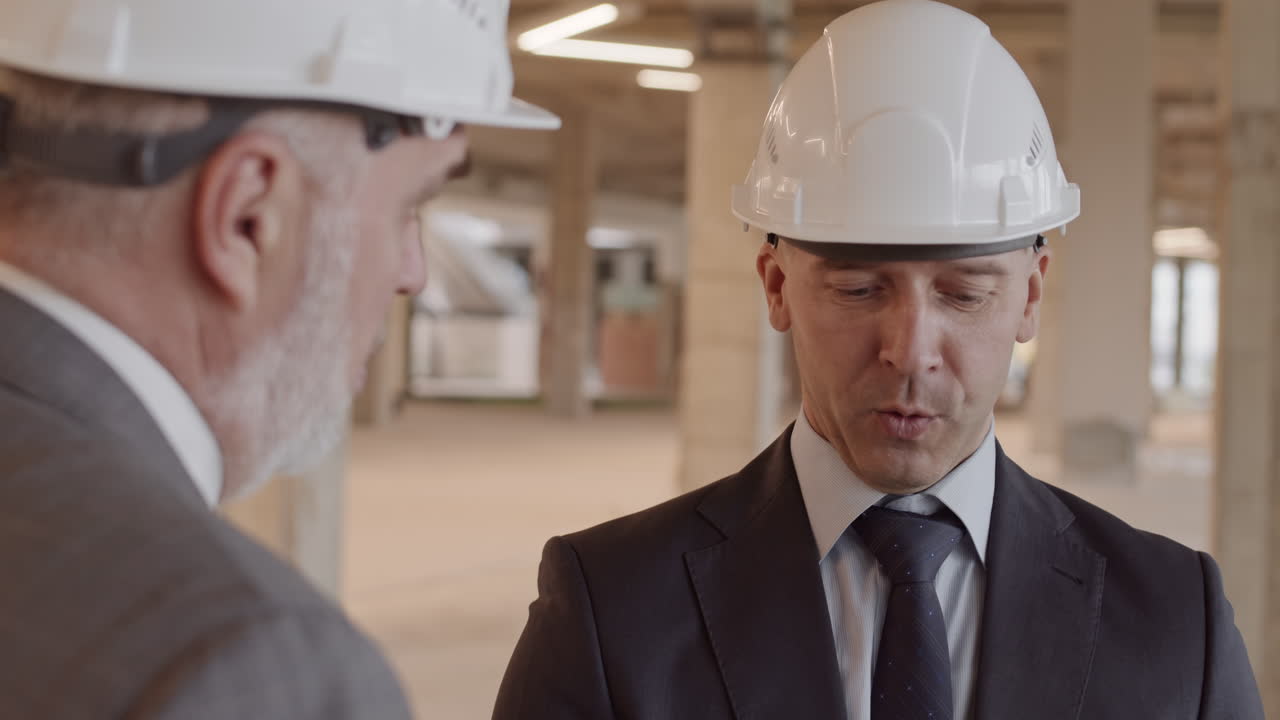 Construction Supervisor Talking to Colleague