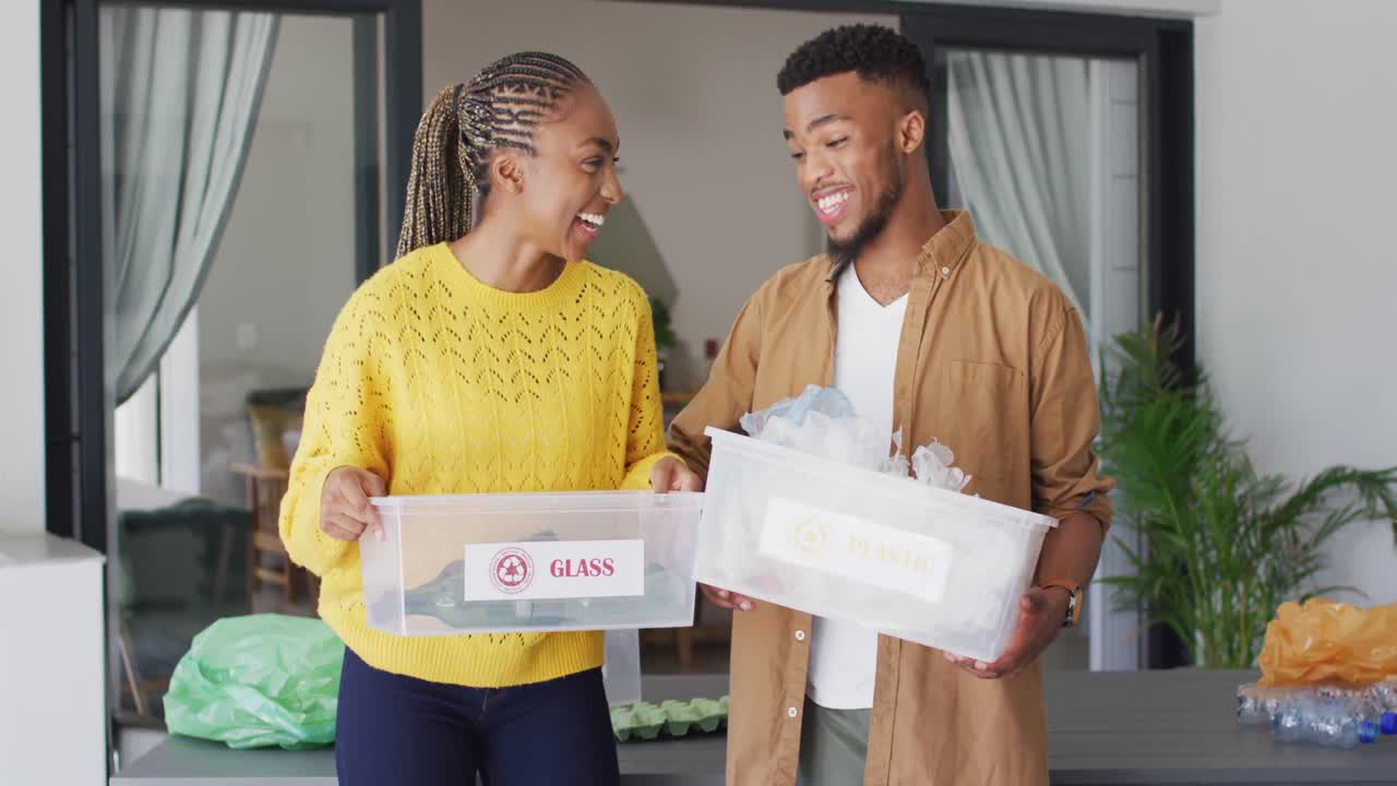 Happy african american couple recycling waste