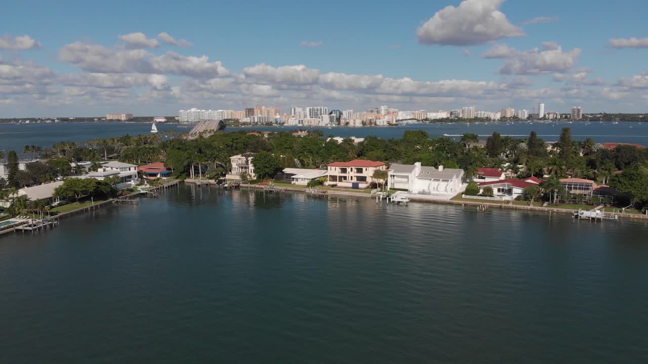 Sarasota, Florida.  Buttery smooth view of luxury island residences and downtown Sarasota located on the Gulf of Mexico.  Clip transitions to the causeway.  Perfect weather and lighting.