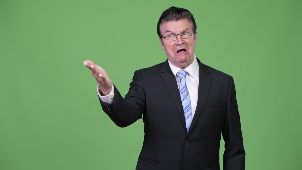 Senior handsome businessman pointing finger