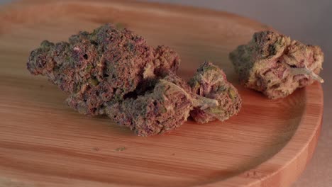 close up panning view of fresh marijuana buds, cannabis flowers, with stems on tray