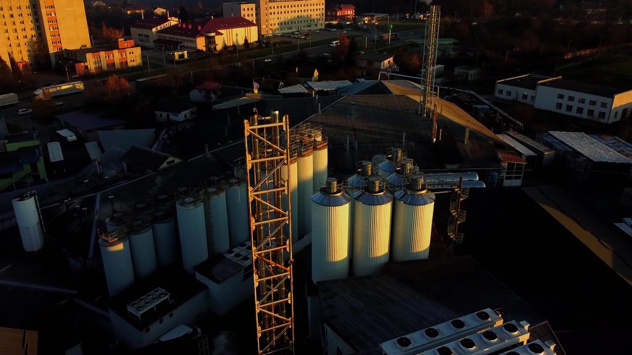 Aerial view of a drone flying over the beer production plant, several rows of tanks.
