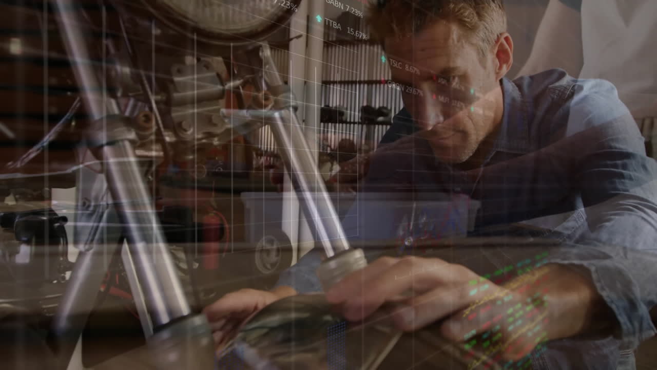 Engineer inspecting motorcycle suspension tube in workshop, showing overlaid stock market charts
