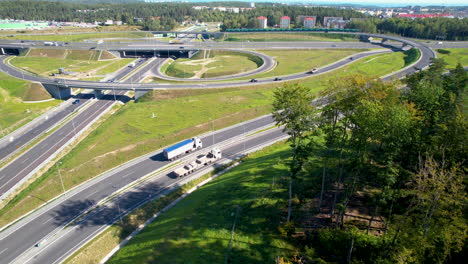 aerial - modern road intersection with safe connections and passage for passenger cars and trucks - wielki kack junction in gdynia - expressway with diverging roads and tunnels