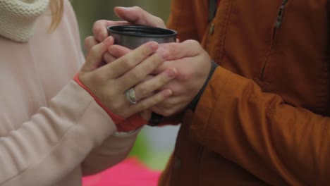 couple enjoying a warm drink in the autumn