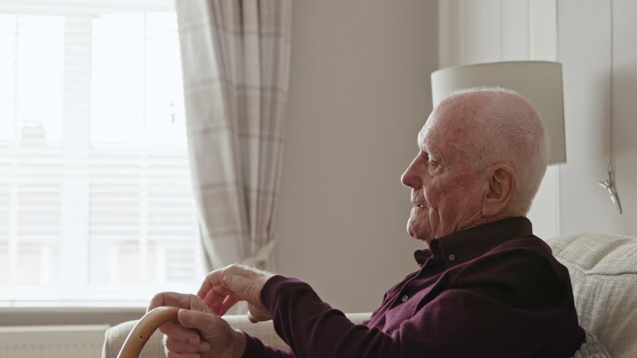 Elderly man sitting by the window
