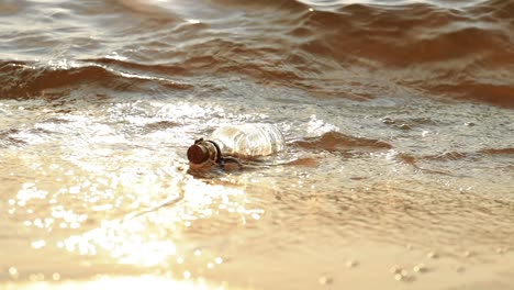 message in the bottle against the sun setting down