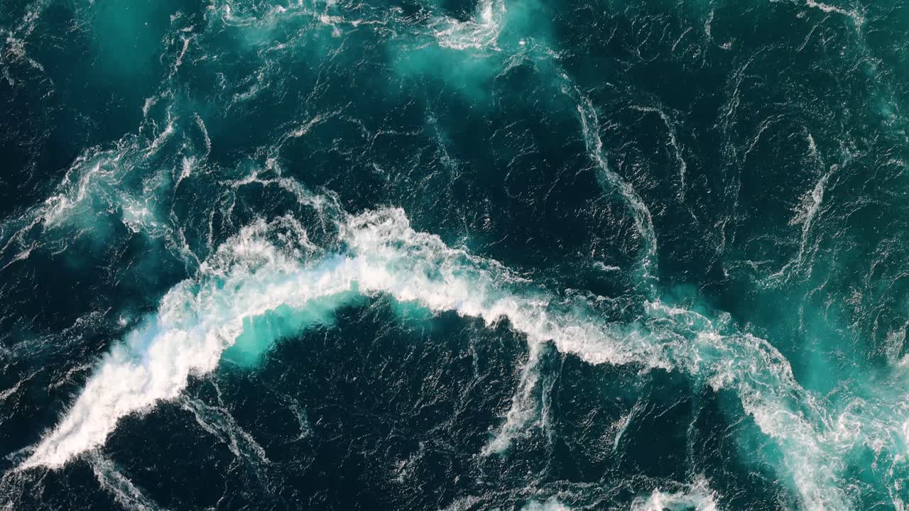 Blue waves of water of the river and the sea meet each other during high tide and low tide.