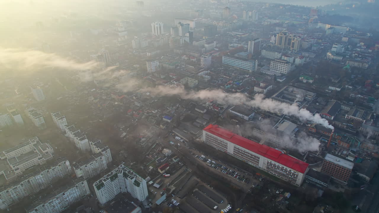 Aerial drone view of Chisinau at sunrise, Moldova. View of the city with fog in the air, multiple buildings, roads, bare trees