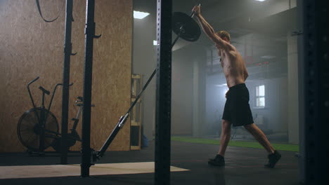 training-of-the-boxer-striking-technique.-Push-the-bar-with-one-hand.-build-up-of-force-blows-for-the-fighter.-Training-a-sporty-man.