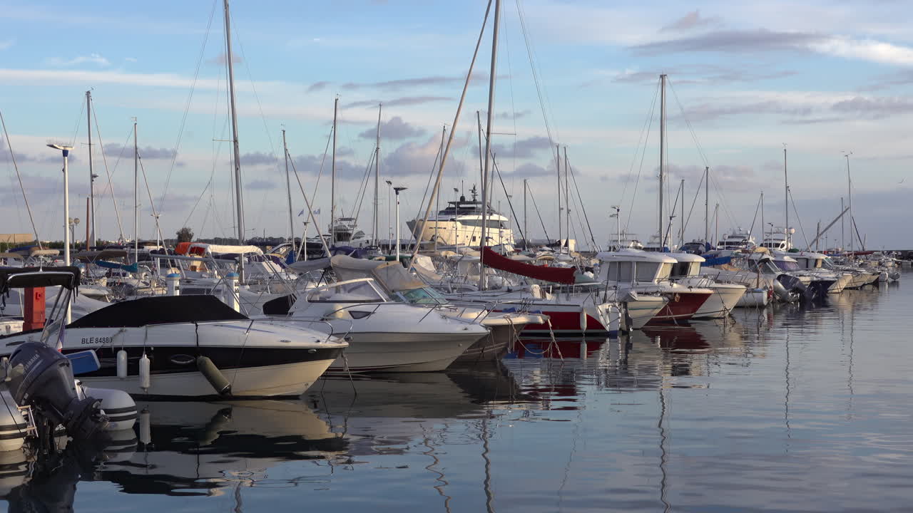 Antibes, France - March 21, 2025: Multiple boats docked in the port in the evening