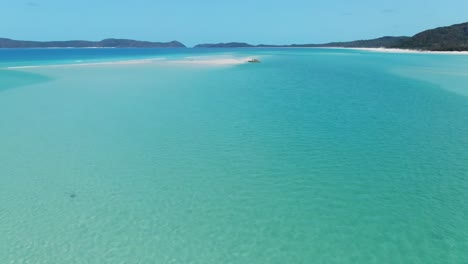 fantastic fast drone flying over four people enjoying the most beautiful beach in the world, white haven beach, queensland