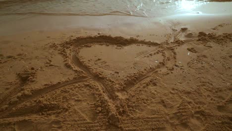 heart shape on beach sand. steady shot. heart draw on sand beach