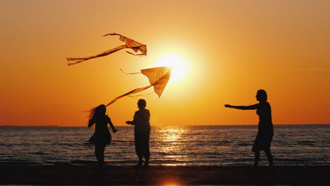 a young family actively spends time together - they play kites