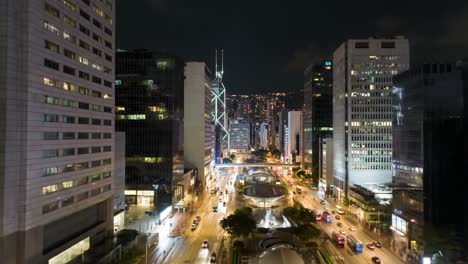 a lively urban landscape is showcased at night, featuring brightly lit buildings and a busy street filled with moving vehicles.