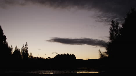 flash of orange underneath the clouds during a time lapse of the sun setting