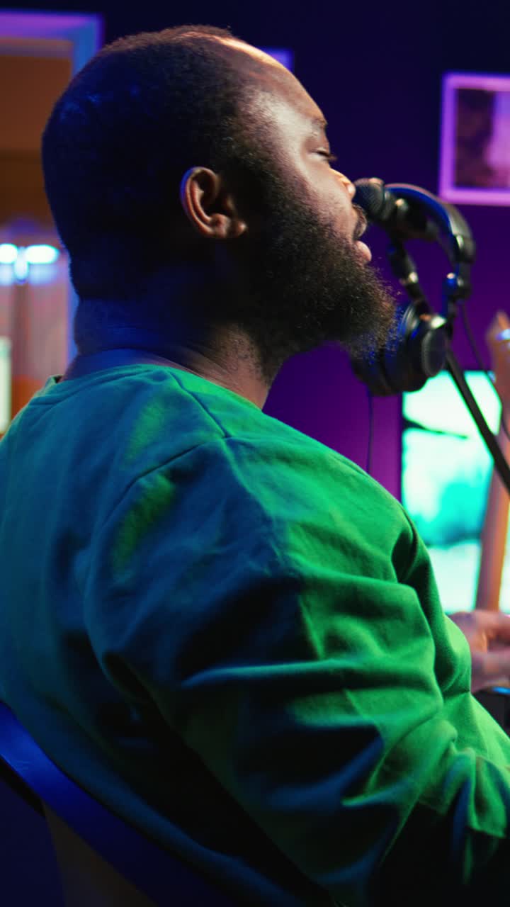 African American Man Singing and Playing Keyboard in Music Studio