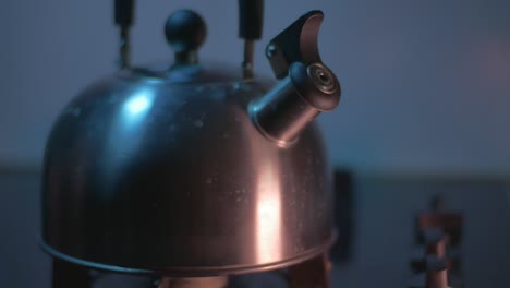 the boiling metal kettle is removed from the gas stove