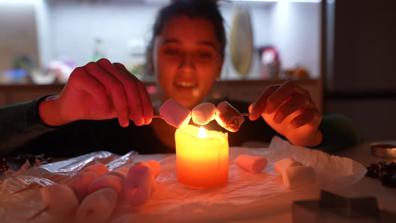 Woman Roasting Marshmallows by Candle Light