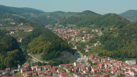 aerial flyover shot of the valley town of ivanjica in serbia on a bright day